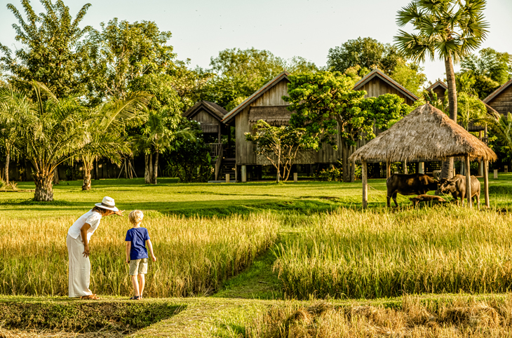 Child and parent explore rural village in Cambodia immersive tourism